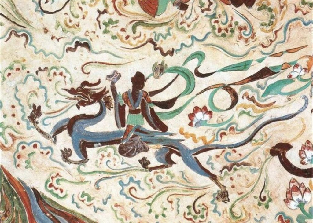 Historic sandstone cliff face of the Mogao Caves in Dunhuang with multi-tier wooden temple facade under clear desert blue sky