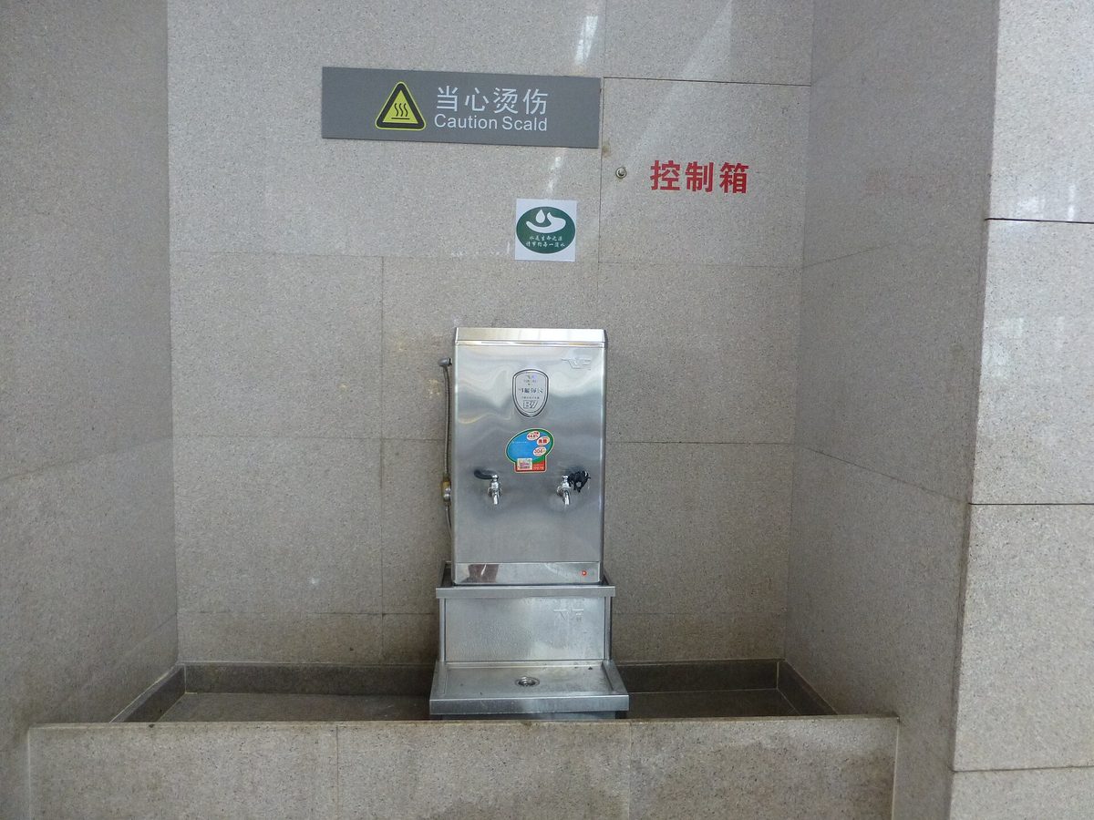 Modern stainless steel airport drinking water dispenser offering chilled warm and boiling water options with digital temperature display