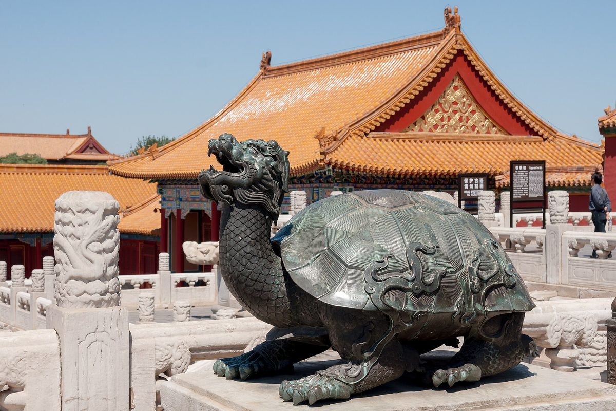 Grand Hall of Supreme Harmony inside the Forbidden City with gleaming yellow-glazed imperial roof tiles and marble terraces under blue sky