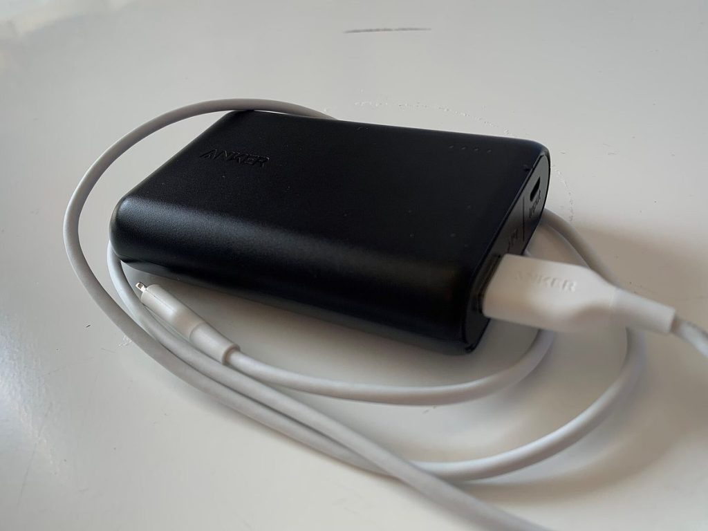 Clear close-up photograph of an approved traveler power bank showing legible 100Wh laser-etched manufacturer specifications