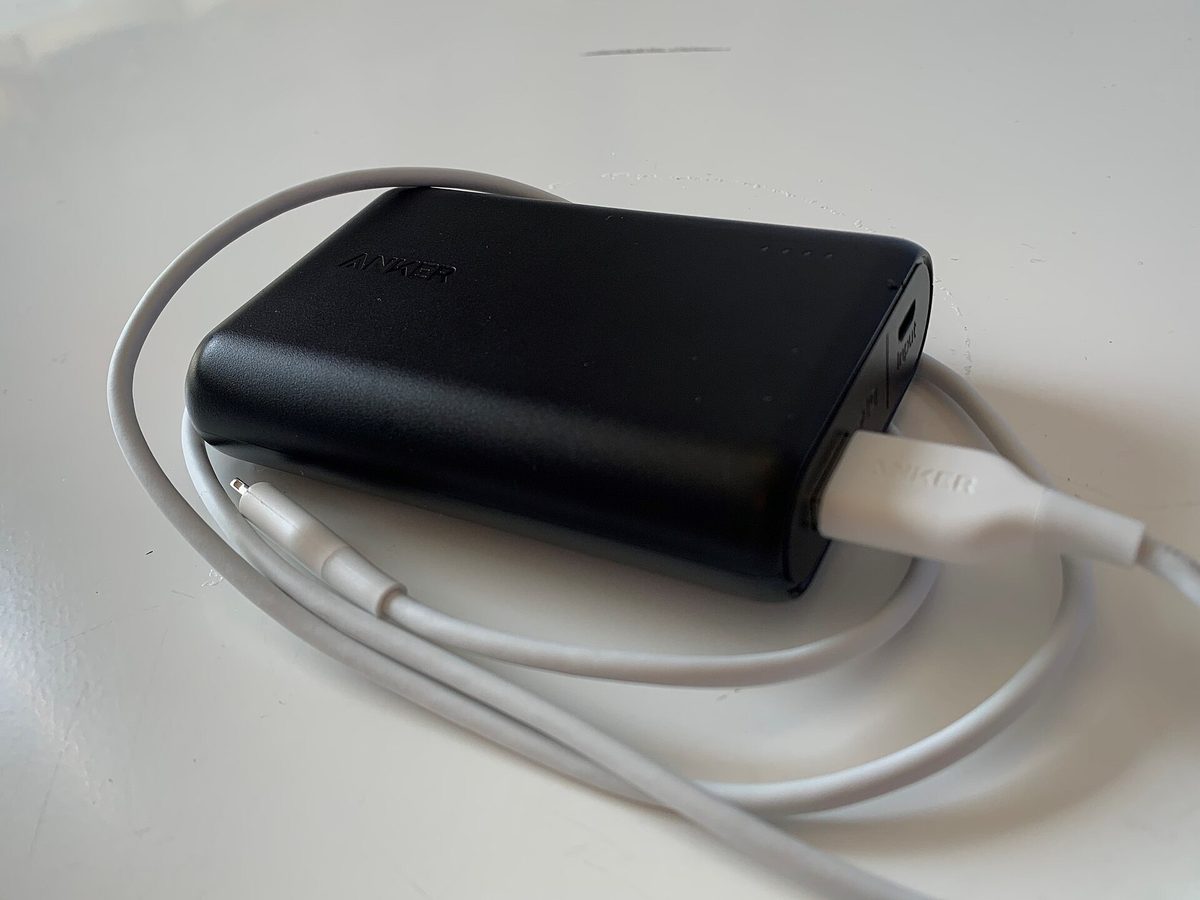 Clear close-up photograph of an approved traveler power bank showing legible 100Wh laser-etched manufacturer specifications